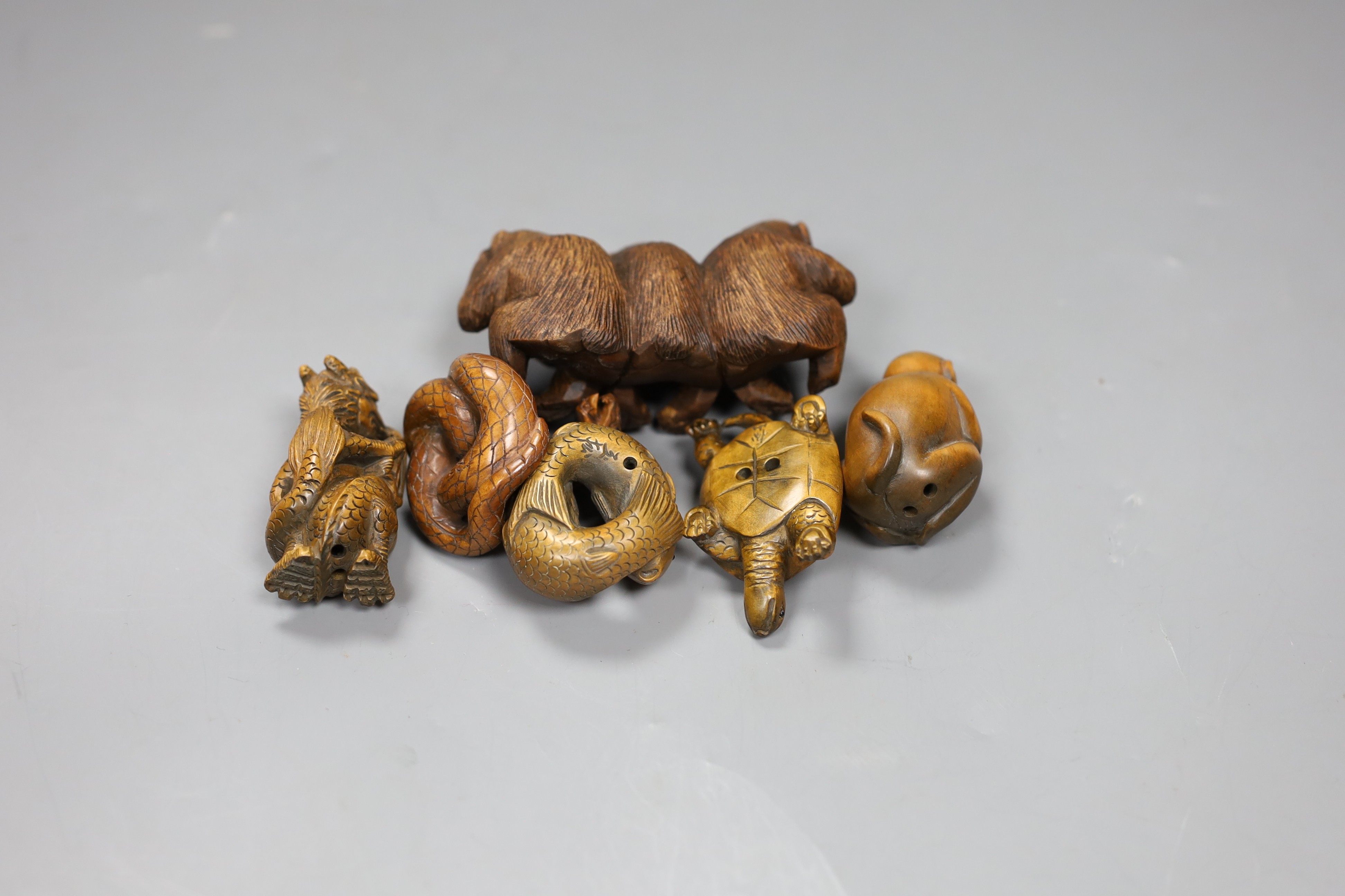 Five wooden animal netsuke; koi, cobra, monkey, tortoise, hear no, see no, say no monkey group, together with a carved wooden figure of a dragon, tallest 5cm